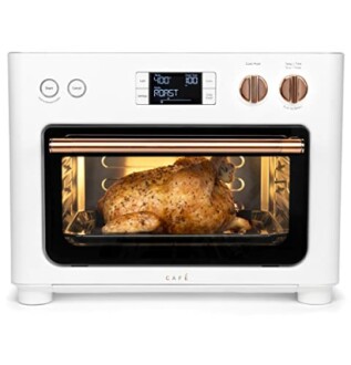 White countertop oven with a chicken roasting inside