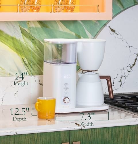 Modern coffee maker on kitchen counter with dimensions labeled